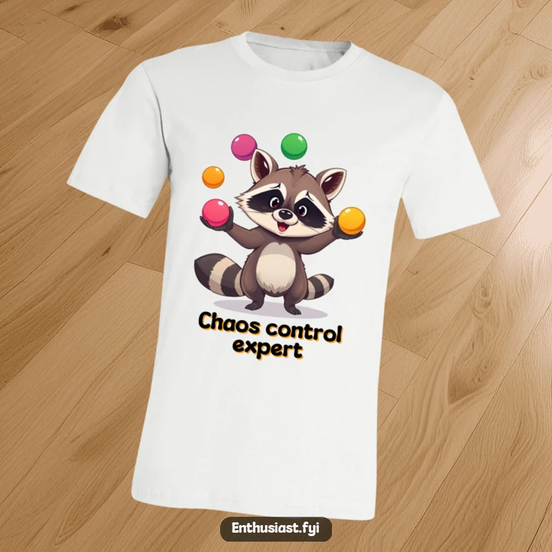 Funny raccoon juggler t-shirt depicts a goofy raccoon expertly juggling three vibrant balls, radiating playful energy and charm.
