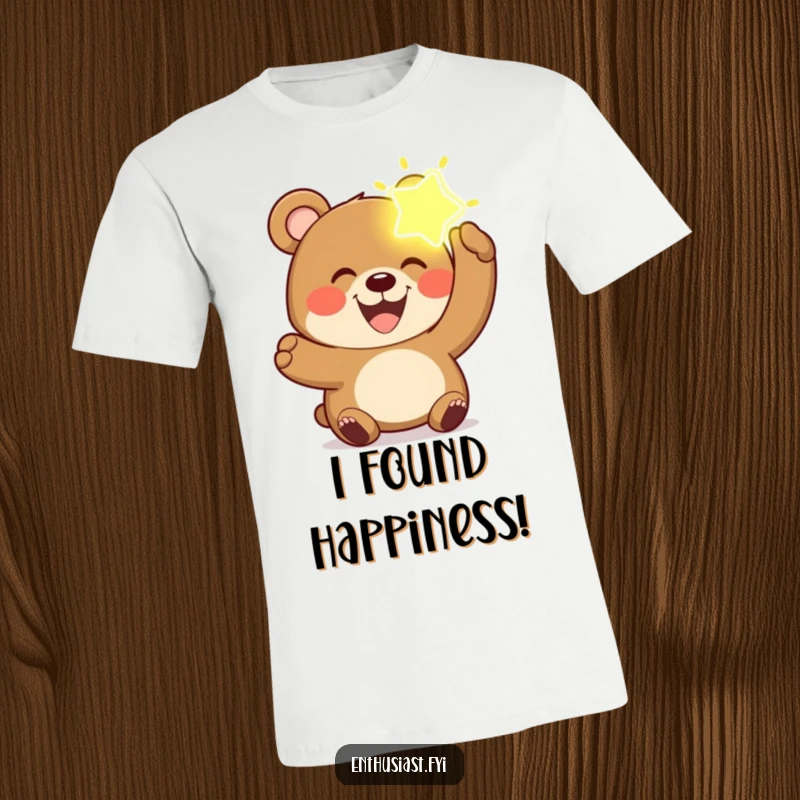 Funny bear t-shirt showing a joyful bear with a wide grin, holding up a bright, glowing, imaginary object.